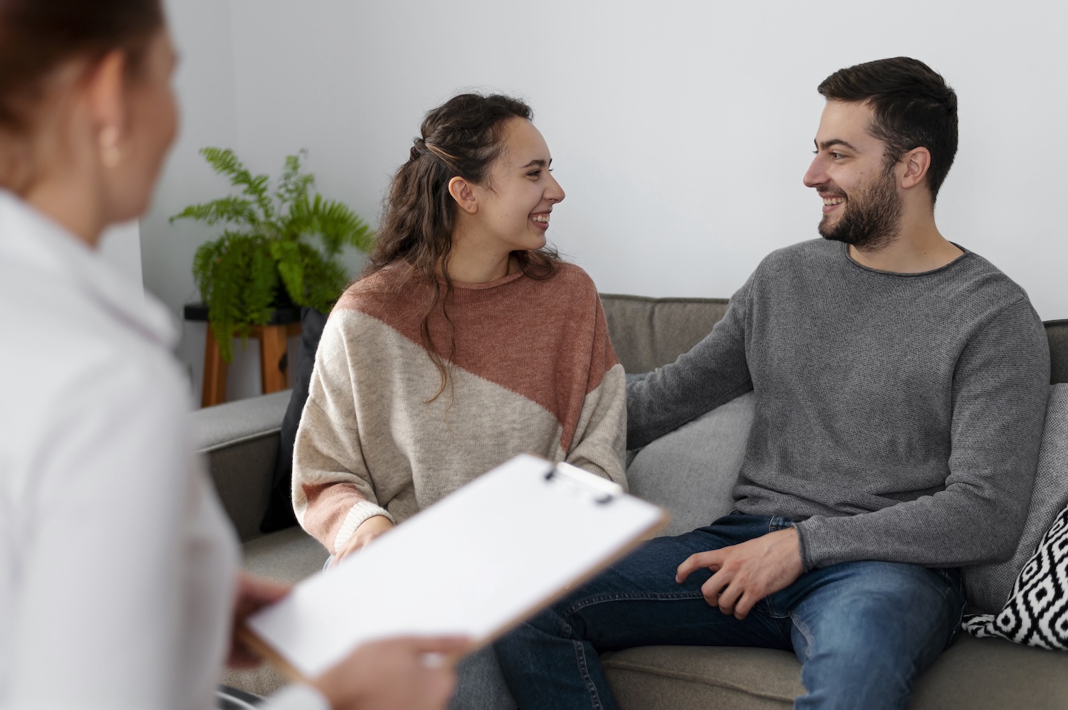 Couple sitting with a therapist discussing love addiction and relationship patterns in London